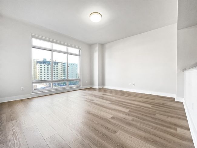 Empty room with wood finished floors and baseboards | Image 5