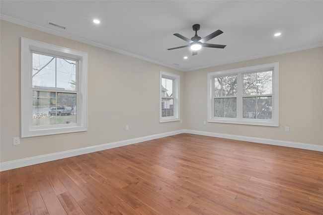 Primary bedroom with abundance of space, hardwood floors, recessed lighting and ceiling fan. | Image 22