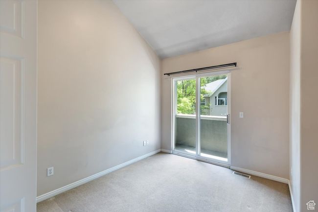 Bedroom with carpet flooring and vaulted ceiling | Image 28