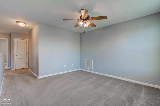 empty room featuring ceiling fan, carpet flooring, and a textured ceiling | Image 30