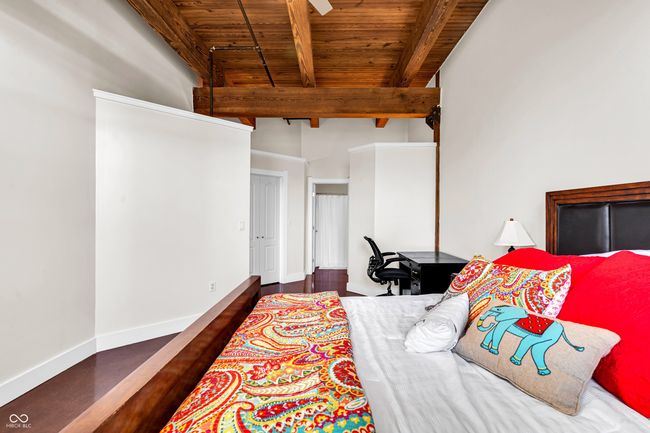 Stunning ceiling height accented with exposed beams and wood | Image 11