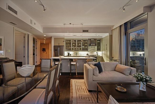 This dusk shot shows the living and kitchen areas with the evening sunset. | Image 31