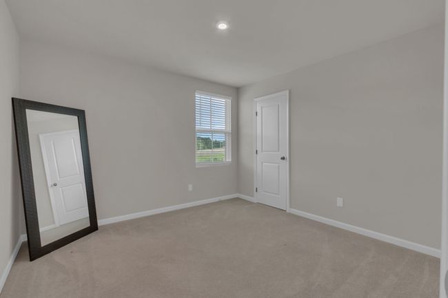 This inviting upstairs bedroom (#2) features a spacious walk-in closet, offering plenty of storage and making it the perfect cozy retreat. | Image 34