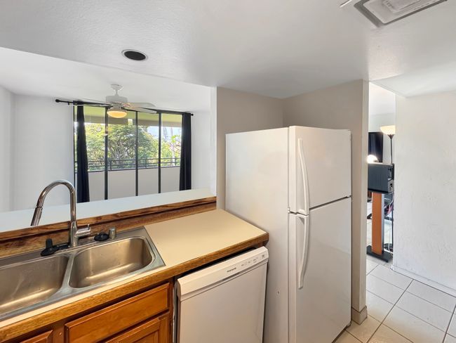 Dishwasher and recently new fridge. Items removed from counter tops and dining room digitally. | Image 6