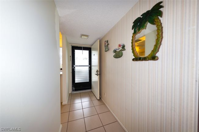 UNIT ENTRANCE. KITCHEN ENTRANCE SHOWN AT LEFT. | Image 6