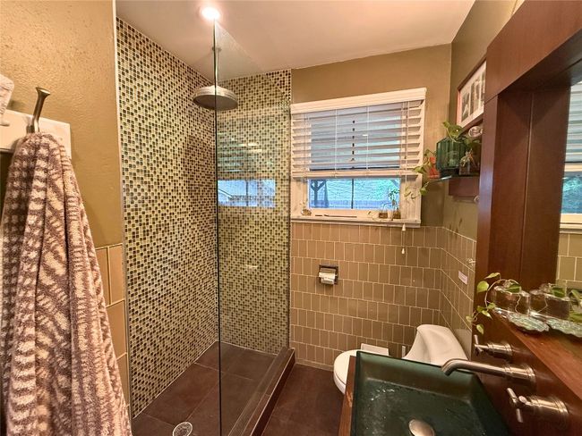Bathroom featuring tile walls, a walk in shower, and tile patterned flooring | Image 11