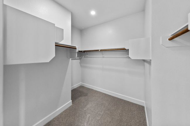 Walk in closet with carpet flooring | Image 17
