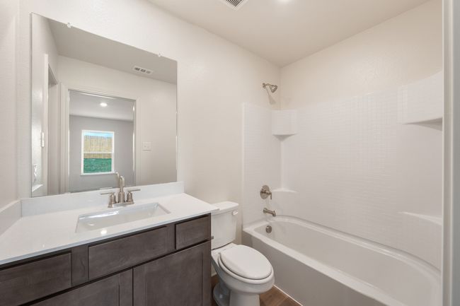 Full bathroom with vanity, shower / bath combination, and wood finished floors | Image 6