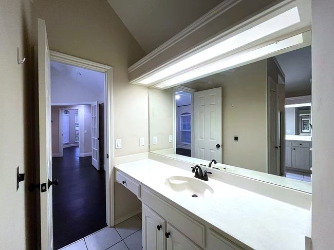 Bathroom with vanity, tile patterned flooring, and lofted ceiling | Image 27