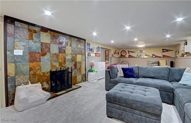 Living room featuring carpet flooring, recessed lighting, and a fireplace | Image 30