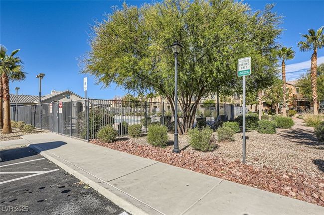 View of community featuring uncovered parking and fence | Image 16