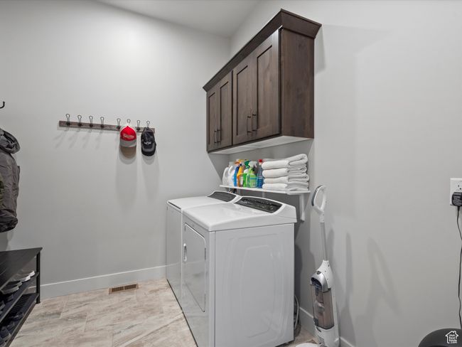 Laundry room with independent washer and dryer, cabinet space, and baseboards | Image 23