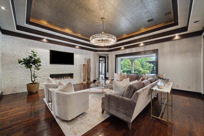 The interior of the home was envisioned by renowned Miami-based contemporary designer Adriana Hoyos. Her carefully curated modern aesthetic elevates luxurious indoor living while effortlessly blending the outdoors in through expansive, uninterrupted picture windows found across the residence. The thoughtfully proportioned layout accommodates substantial furnishings with ease, offering the perfect setting for both relaxed evenings and sophisticated entertaining. | Image 13