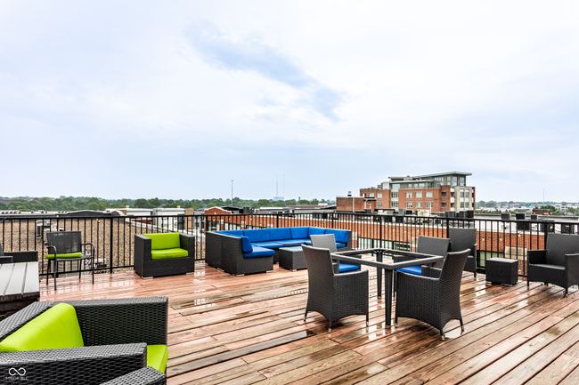wooden deck with an outdoor hangout area | Image 34