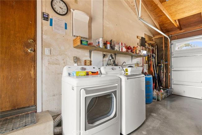 Laundry area in garage | Image 34