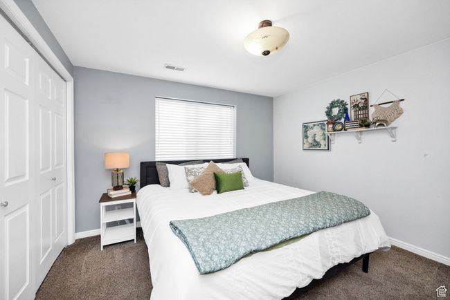 Bedroom featuring carpet, visible vents, and baseboards | Image 32