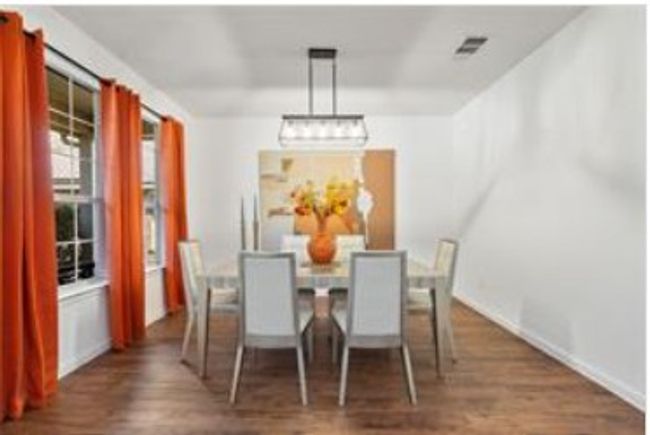 Dining area with baseboards, visible vents, and dark wood-style flooring | Image 20