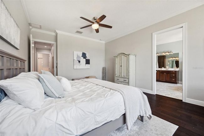 View of master bedroom with view of marble bathroom to right and entrance from hall to back left. | Image 46