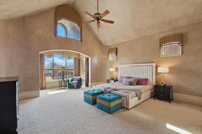 The primary bedroom has a private entry, a coffee bar and drink fridge, a sitting area and private patio overlooking the pool, and a movable bookshelf that connects to the dining room for ease of moving furniture in and out. | Image 19