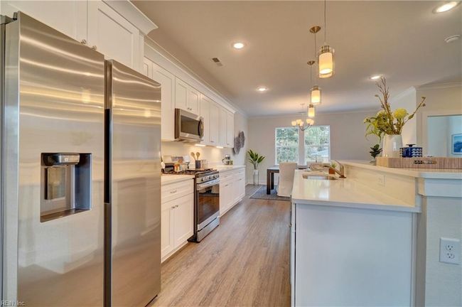 Kitchen with gas range and all stainless steel appliances | Image 9