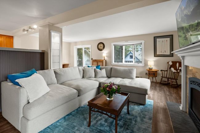 Living room featuring wood finished floors and a fireplace | Image 12