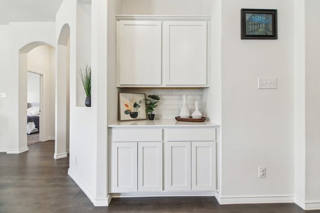 Bar with dark wood-style floors, arched walkways, baseboards, and backsplash | Image 14
