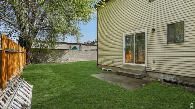 View of yard with entry steps and a fenced backyard | Image 18