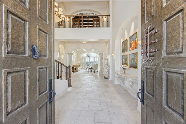 The impressive handmade and hammered front double doors were imported from an Italian Monastery. | Image 5