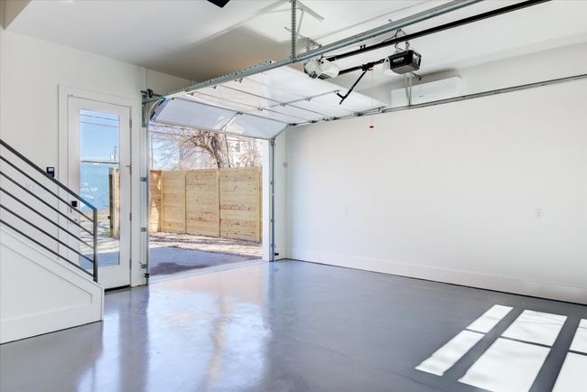 Stairs from the primary's flex space lead down to the garage, which is climate controlled with its own mini split system. If used as a garage, there is gated access to Santa Rosa St behind. | Image 28