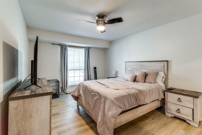 Bedroom featuring light wood-style flooring and a ceiling fan | Image 17