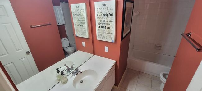 Bathroom featuring vanity, tile patterned flooring, and shower combination | Image 10