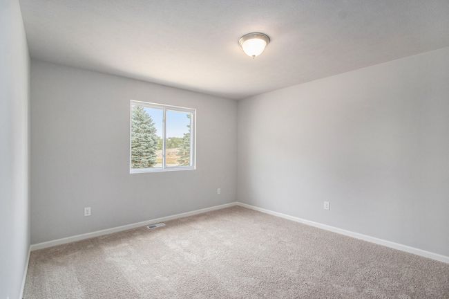 The luxurious primary suite includes a private bath and large walk-in closet. | Image 11