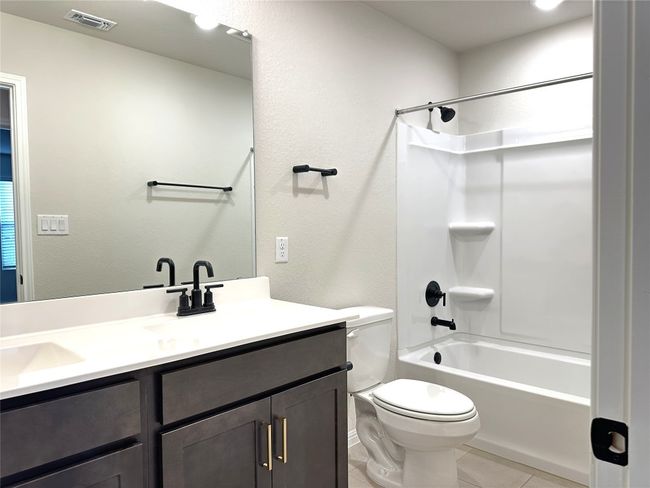 Full bathroom-3 with toilet, vanity, tile patterned flooring, and bathing tub / shower combination | Image 18