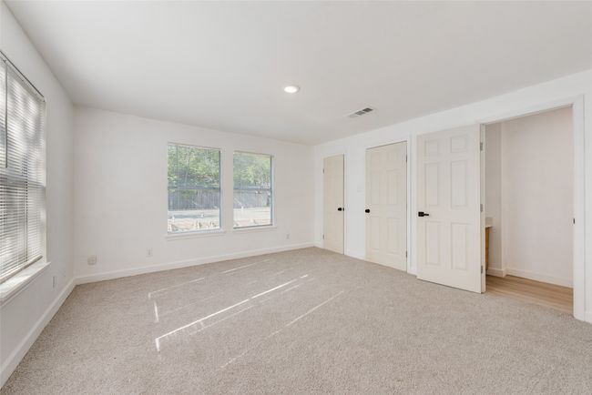Unfurnished bedroom featuring baseboards, carpet flooring, and visible vents | Image 15
