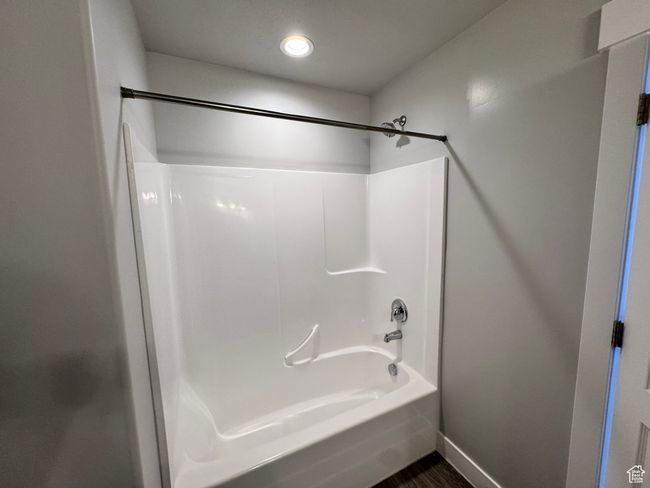 Full bath featuring wood finished floors, recessed lighting, tub / shower combination, and baseboards | Image 15