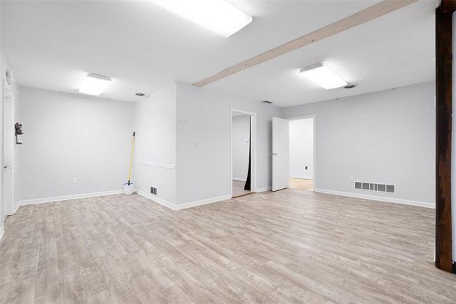 Most recently used as dining space with doorways to office room & storage room | Image 4