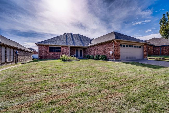 Single story home featuring a garage and a front lawn | Image 7
