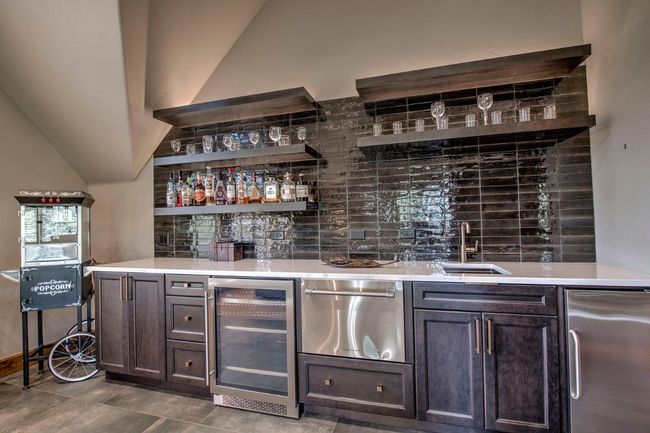 Play some games, or catch THE game, in this fun family room-complete with wet bar. | Image 25