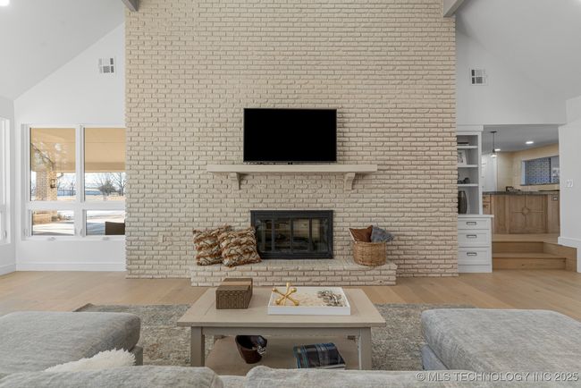 Formal living room with floor-to-ceiling brick fireplace | Image 29