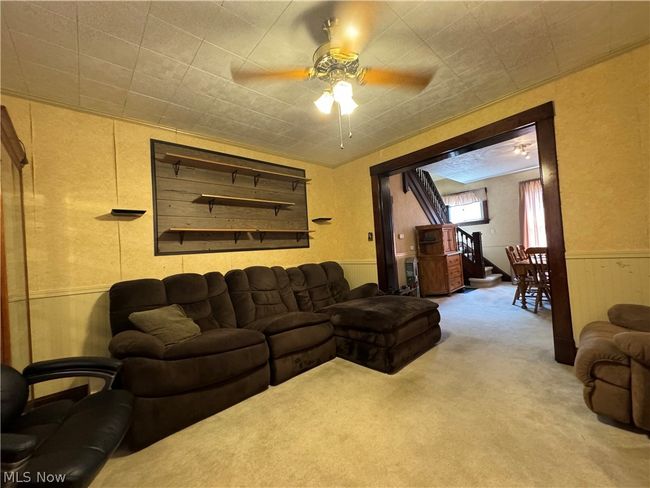 Carpeted living room featuring ceiling fan | Image 7