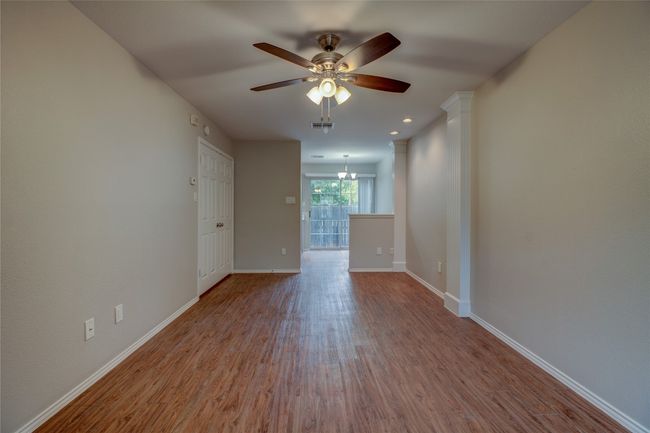 Spare room featuring ceiling fan, wood finished floors, and baseboards | Image 11