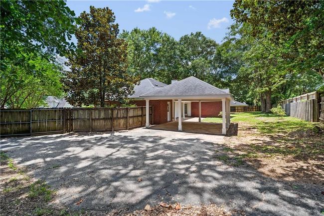 Fenced backyard featuring a patio area and a carport | Image 28