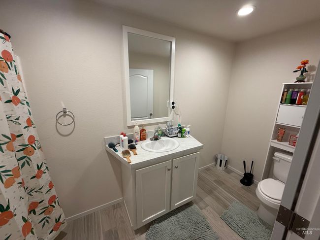 Bathroom with vanity, wood finished floors, and a shower with curtain | Image 8