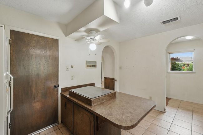 Bathroom with tile patterned floors, a ceiling fan, and a textured ceiling | Image 20