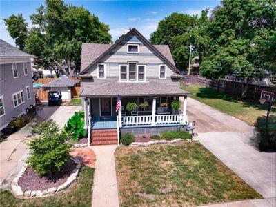 Victorian-style house with covered porch and a front lawn | Image 1