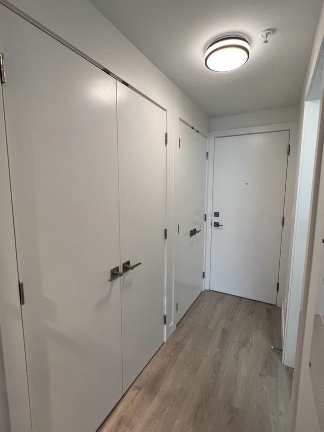 Hallway featuring light wood-style flooring | Image 5
