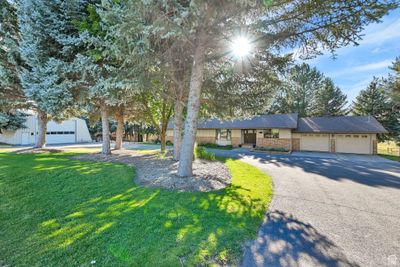 View of front of property with a garage and a front lawn | Image 2