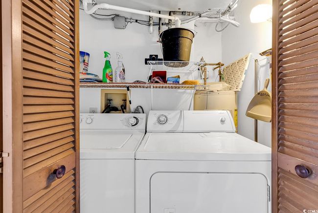 Clothes washing area featuring washing machine and clothes dryer and laundry area | Image 12
