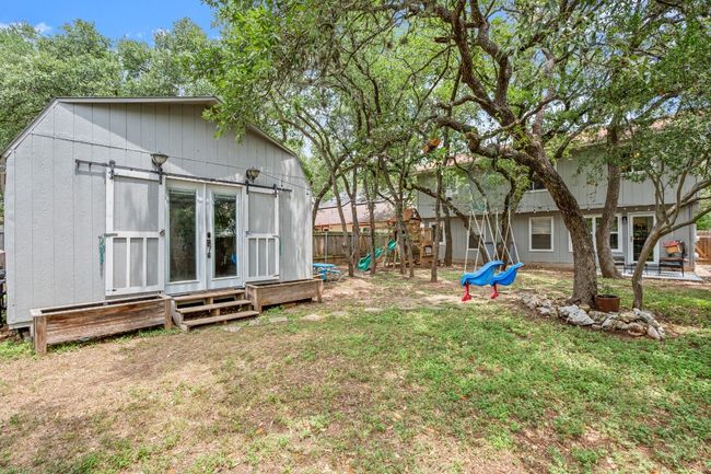 The outdoor office sits in the backyard, offering a private, secluded space with plenty of natural light and a connection to the peaceful outdoor environment | Image 28