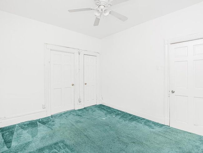 Unfurnished bedroom with a ceiling fan and carpet | Image 10